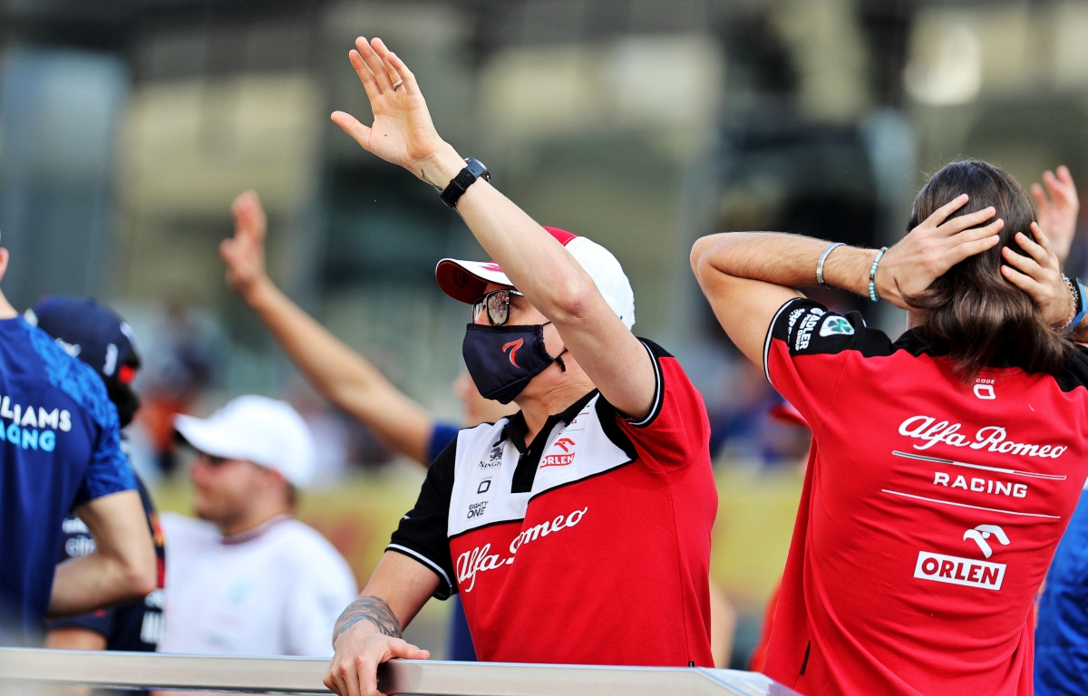 Kimi Raikkonen waves on the drivers' parade. Abu Dhabi December 2021.Kimi Raikkonen waves on the drivers' parade. Abu Dhabi December 2021.