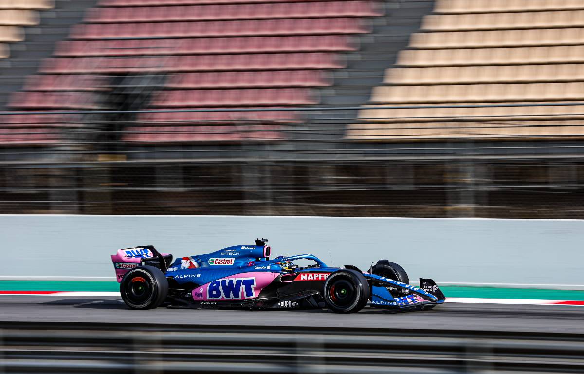 Fernando Alonso Alpine passes an empty grandstand. Barcelona February 2022.