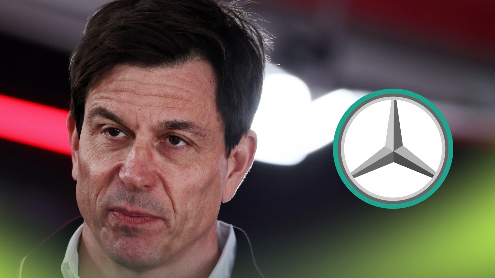 Toto Wolff speaks to the media with a prominent Mercedes logo alongside him