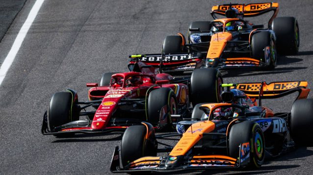 Carlos Sainz of Ferrari in a McLaren sandwich