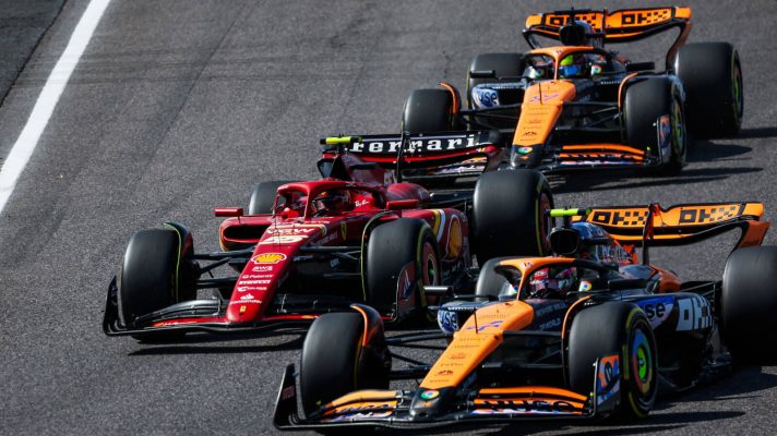Carlos Sainz of Ferrari in a McLaren sandwich