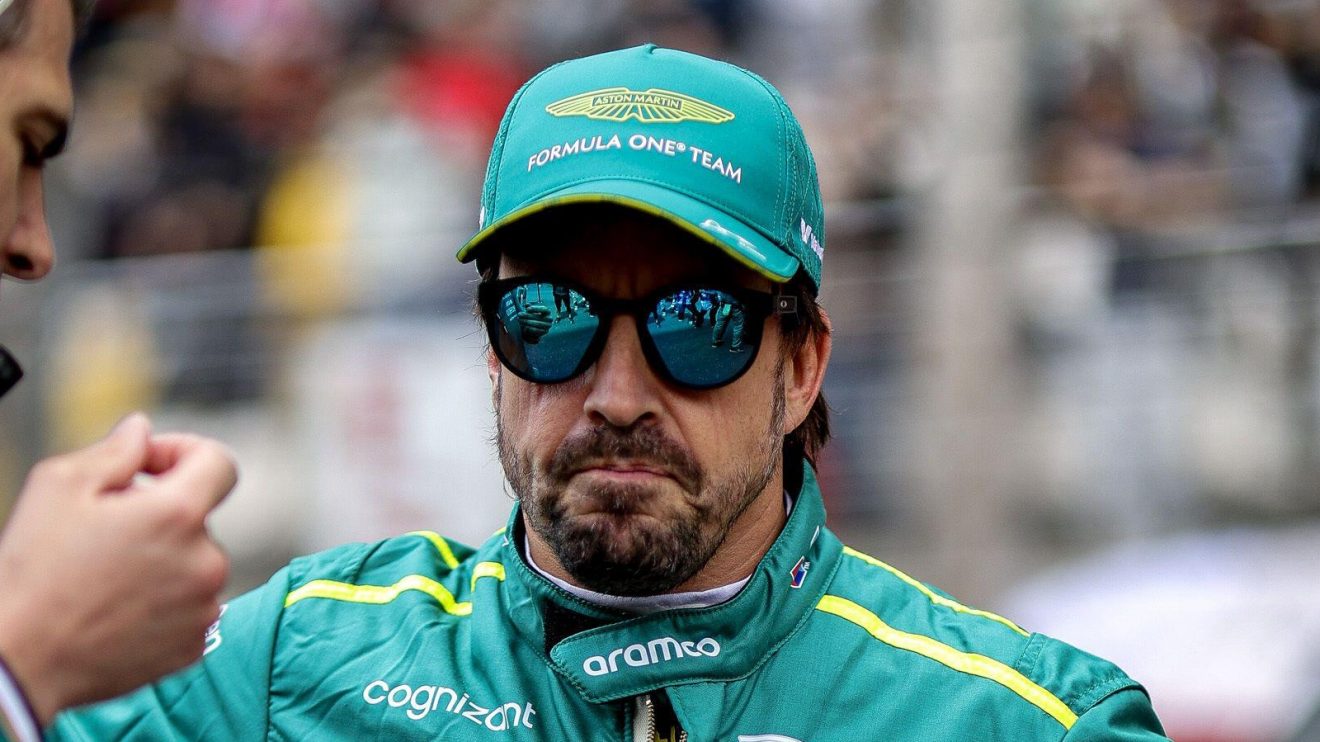 Aston Martin driver Fernando Alonso wearing sunglasses.