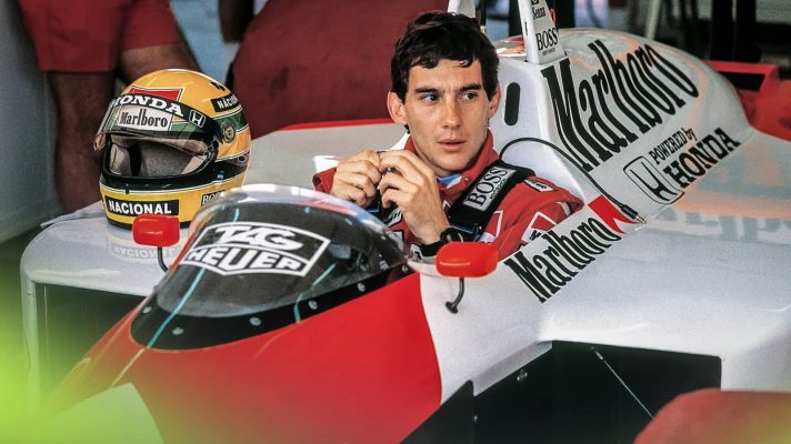 Ayrton Senna sits in the cockpit of his McLaren MP4/4 in the garage at the 1988 San Marino Grand Prix