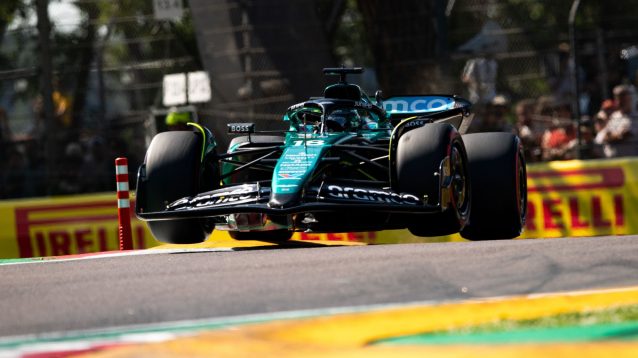 Lance Stroll, Aston Martin, off the ground as he rides the Imola kerbs.
