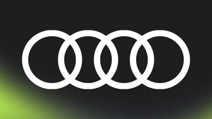 A white Audi logo against a black background with PlanetF1.com's lime-green mist at the bottom