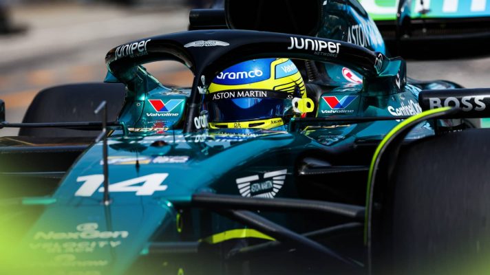 A close-up shot of Fernando Alonso driving down the pit lane at Imola