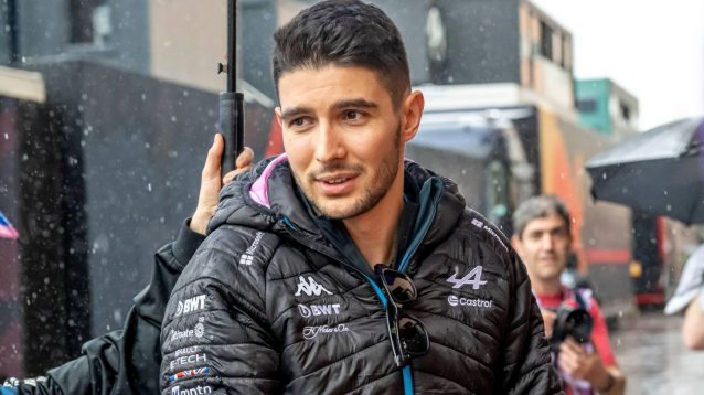 Alpine driver Esteban Ocon under an umbrella at the 2024 Monaco Grand Prix.