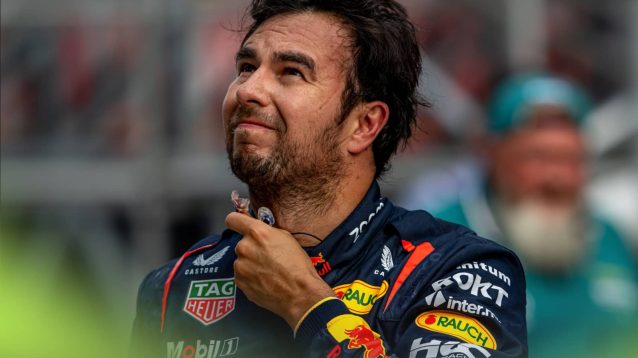 Sergio Perez grimaces as he removes his earplugs