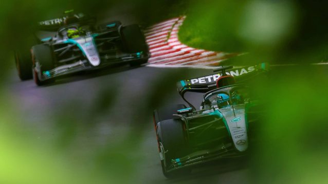 Mercedes drivers George Russell and Lewis Hamilton photographed through the trees in Montreal