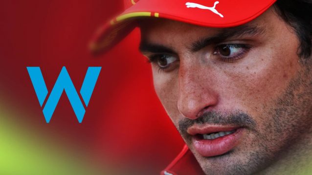 A close-up shot of Carlos Sainz with a prominent Williams logo alongside him