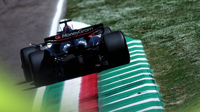 A rear-facing shot of Oliver Bearman's Haas running over a kerb at Imola