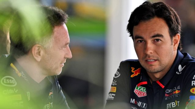 Christian Horner and Sergio Perez in conversation at a table in the Montreal paddock
