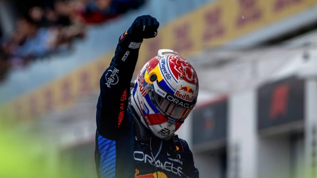 Max Verstappen lowers his head as he punches the air in celebration after climbing out of his Red Bull in Canada