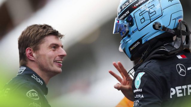 Max Verstappen smiles in conversation with George Russell in parc ferme in Canada