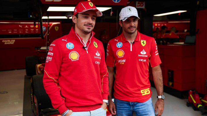 Charles Leclerc and Carlos Sainz Jr. post in front of the Ferrari garage before the 2024 Spanish Grand Prix