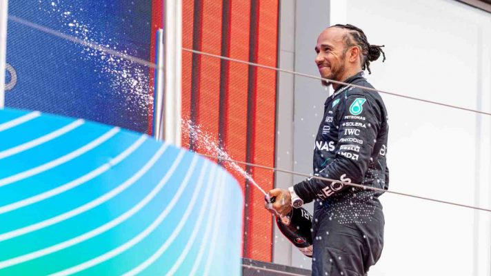 Mercedes driver Lewis Hamilton sprays champagne on the podium