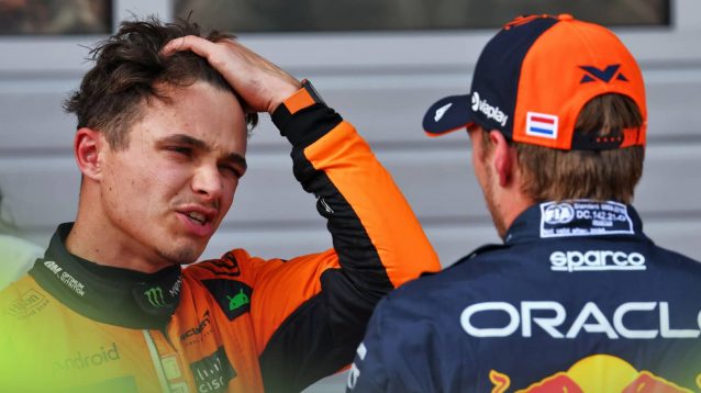 Lando Norris grimaces in conversation with Max Verstappen in Austria