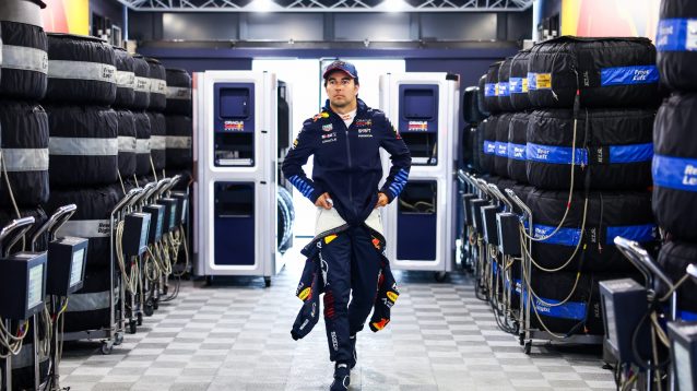 Sergio Perez walks through the Red Bull garage