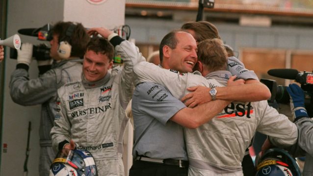 Ron Dennis hugs Mika Hakkinen, David Coulthard walks past
