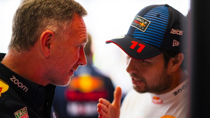 Sergio Perez demonstrates to Red Bull team principal and CEO Christian Horner