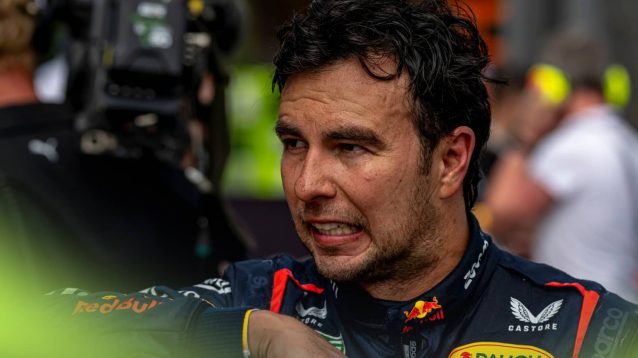 Sergio Perez looks uneasy after removing his helmet in parc ferme