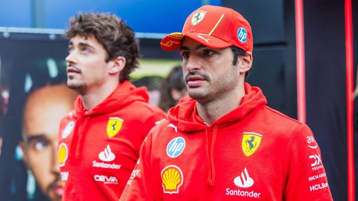 Williams target Carlos Sainz walks in the Spa paddock with Ferrari team-mate Charles Leclerc
