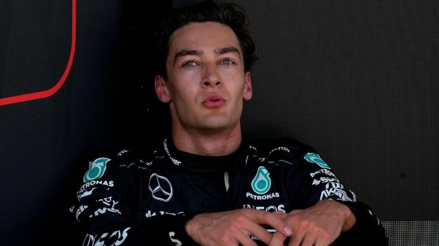 Mercedes driver George Russell crouched down after crossing the line first at the 2024 Belgian Grand Prix.