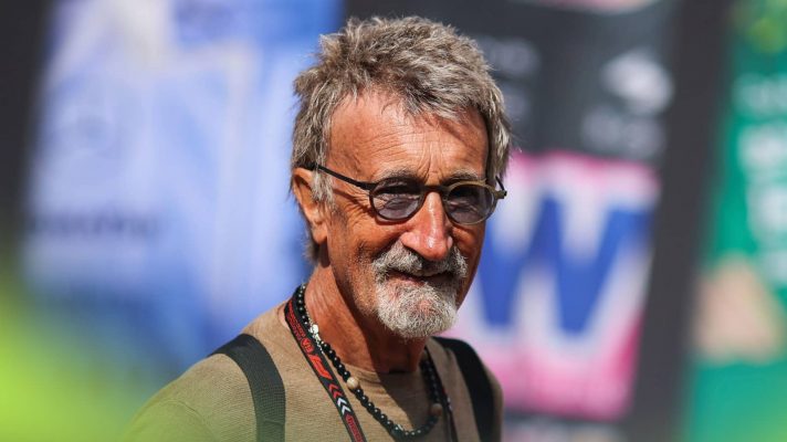 Eddie Jordan smiles as he makes his way through the paddock in Monaco