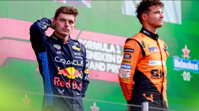 Max Verstappen scratches the back of his head as Lando Norris looks on during the podium ceremony at Zandvoort