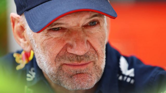 A close-up shot of Adrian Newey wearing a Red Bull cap