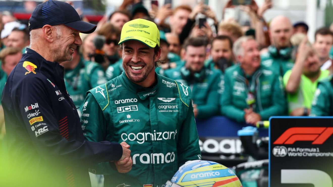 Adrian Newey and Fernando Alonso smile as they shake hands ahead of the podium ceremony in Canada 2023