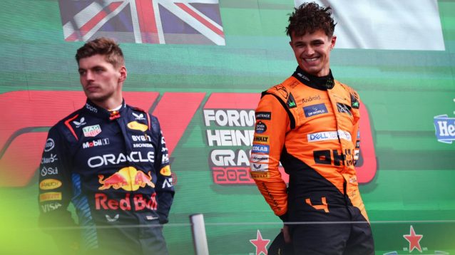 Lando Norris smiles during the podium ceremony at Zandvoort as Max Verstappen looks on