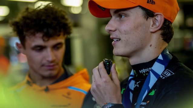 Lando Norris looks down as Oscar Piastri is interviewed in Baku