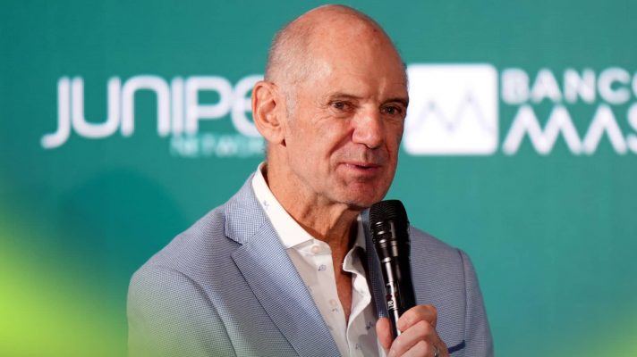 Adrian Newey speaks into a microphone during his Aston Martin unveiling
