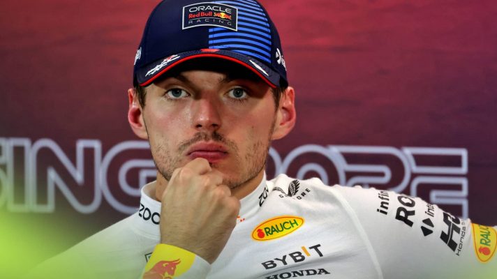 Max Verstappen sits with his hand resting on his chin in the post-qualifying press conference in Singapore