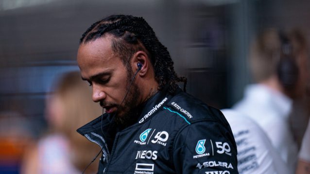 Lewis Hamilton with his head down on the grid