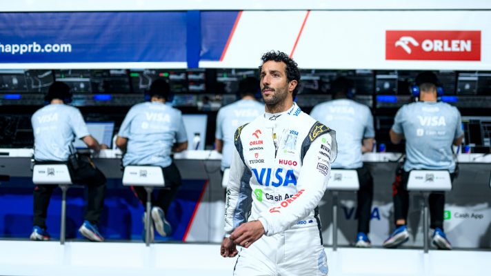 Daniel Ricciardo walking away from the pit wall.