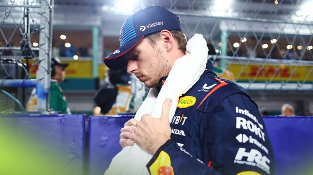 Max Verstappen looks down on the Singapore grid with a towel draped over his shoulders