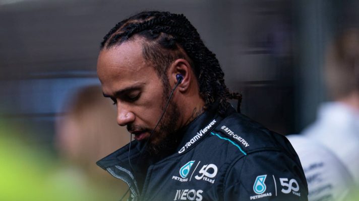 Lewis Hamilton lowers his head on the starting grid in Singapore