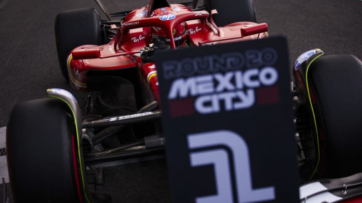 Carlos Sainz parking behind the No1 board in parc ferme