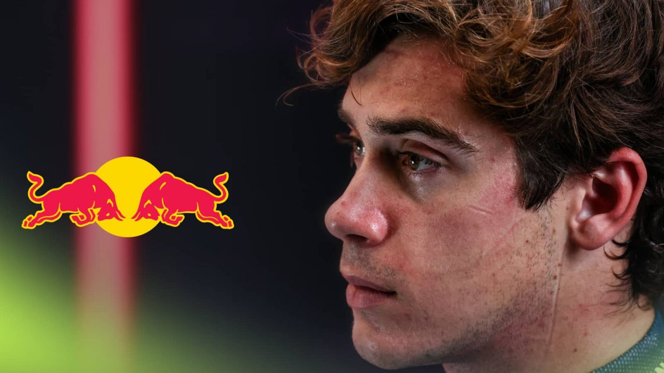 A close-up shot of Franco Colapinto with a prominent Red Bull logo alongside him
