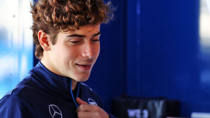 Franco Colapinto smiling in the Williams garage
