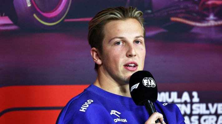 Liam Lawson speaking into a microphone
