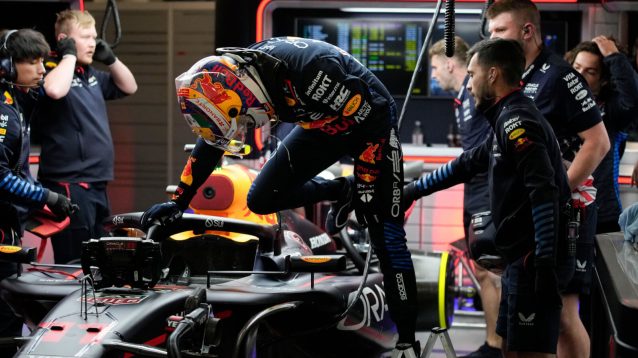 Sergio Perez climbs out of his RB20 in the Red Bull garage