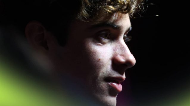 A close-up shot of Franco Colapinto with light illuminating his face in the Las Vegas paddock