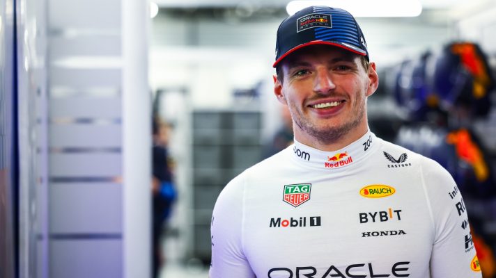 Max Verstappen smiles in the garage