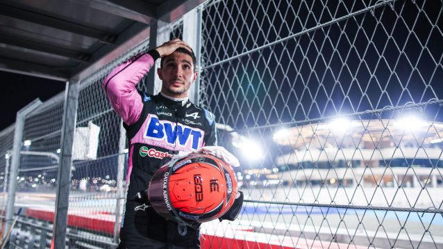 Esteban Ocon standing at the side of the track after retiring