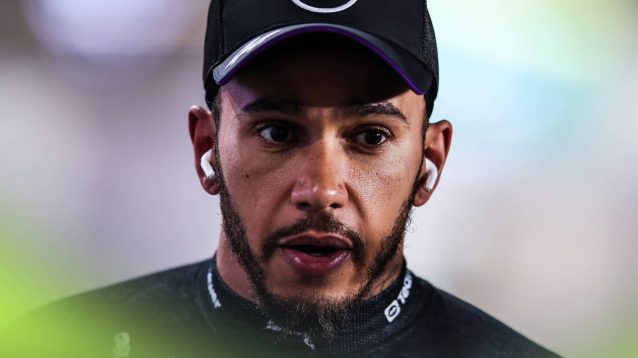 A close-up shot of Lewis Hamilton looking stressed