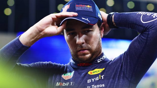 Sergio Perez looks strained as he adjusts his cap in Abu Dhabi