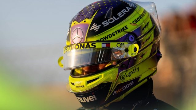 Lewis Hamilton with his visor open on the grid at sunset in Abu Dhabi